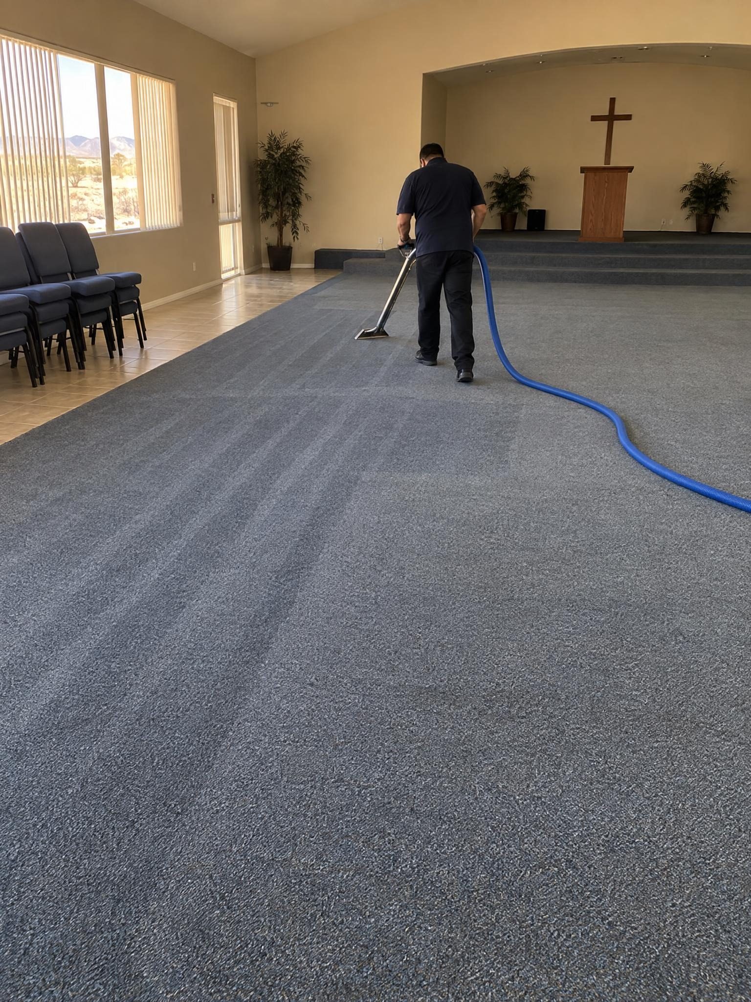 Cleaning the carpet of a large community hall